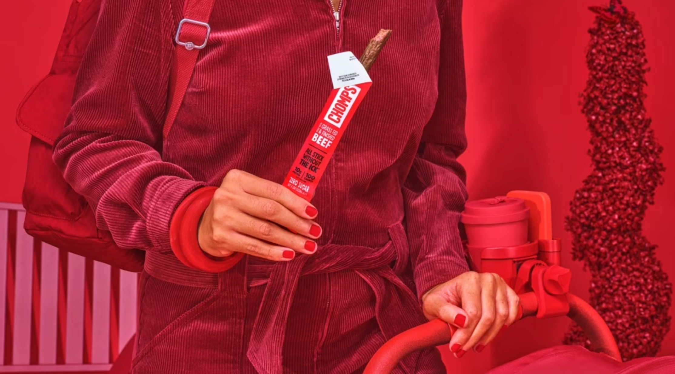 Woman holding a Chomps stick.