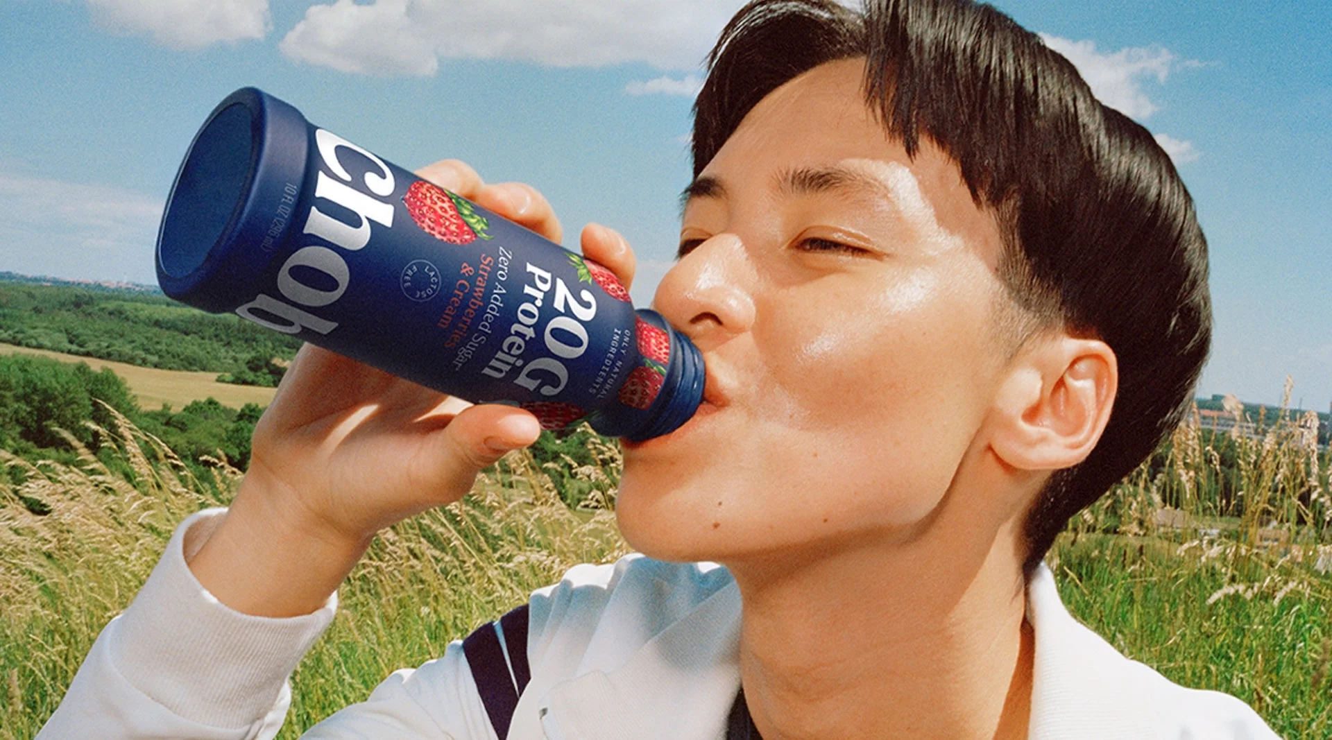 man drinking chobani protein drinkable yogurt