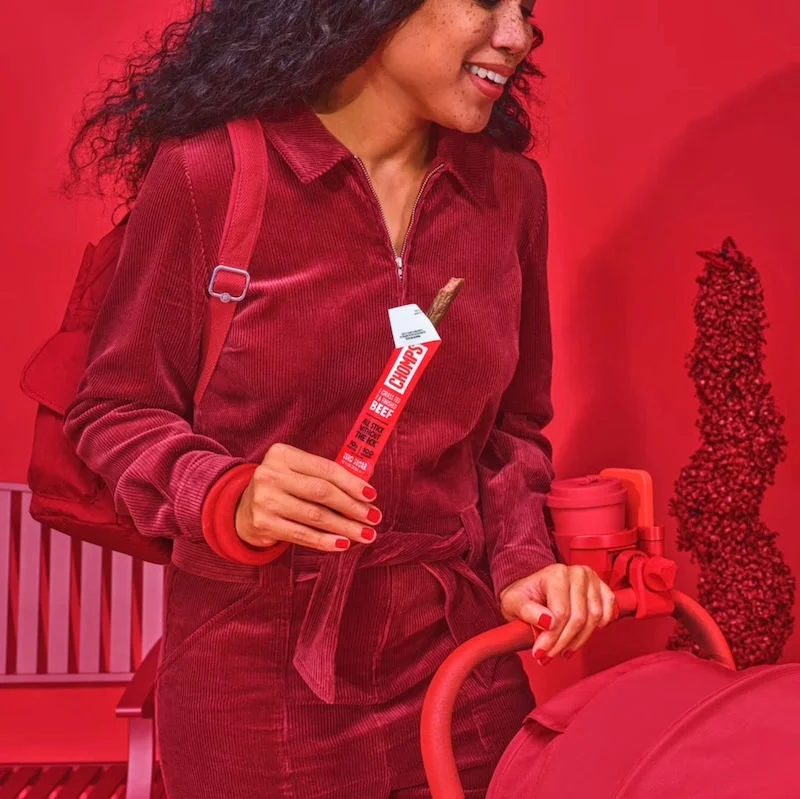 Woman holding a Chomps stick.