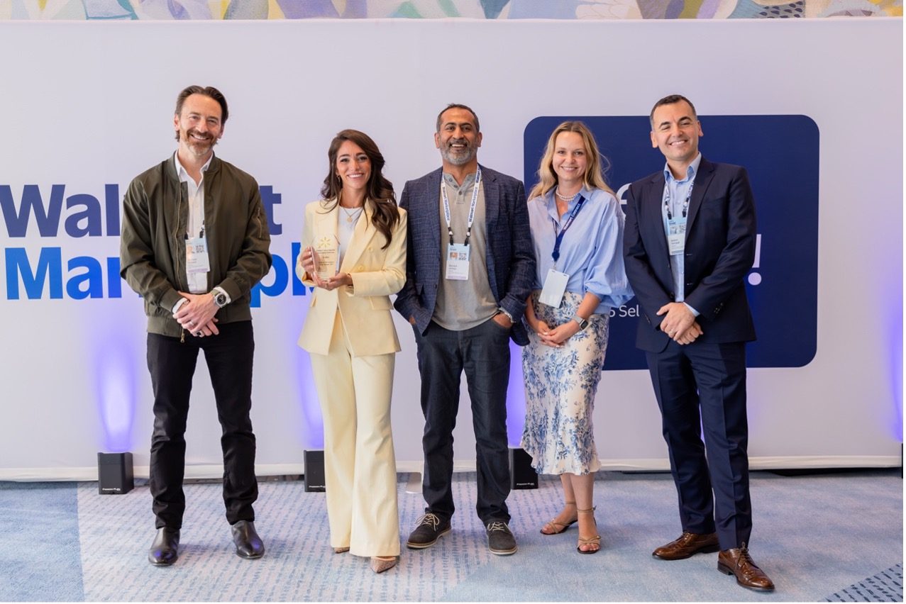 Group of people with one holding an award
