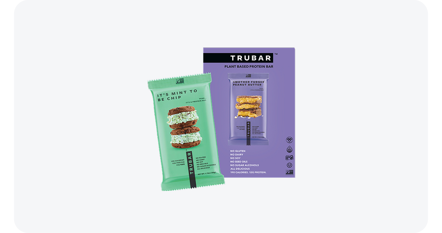 Trubar plant-based protein bar packaging in mint green and purple with dessert images.
