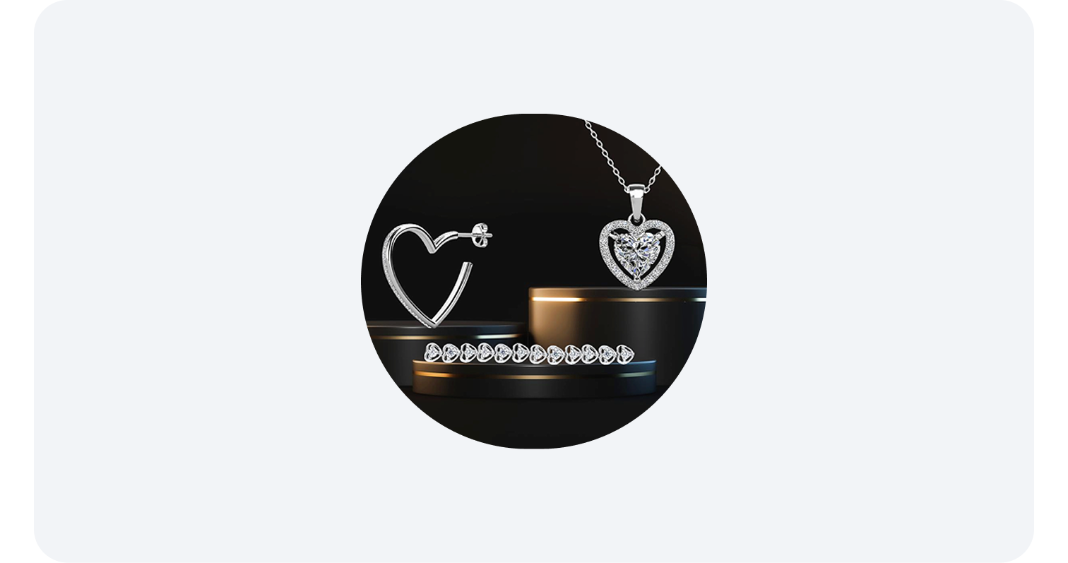  Heart-shaped silver jewelry set with earrings, a necklace, and a bracelet on black stands.